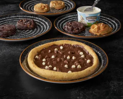 Delicious chocolate pizza topped with rich chocolate sauce and chocolate-sprinkled toppings
